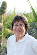 person smiling, with cactus in background